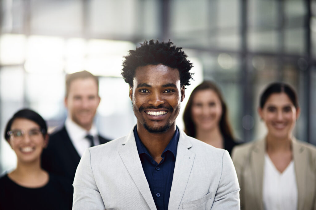 Emerging leader showcasing professional growth with a motivated team in a modern office.